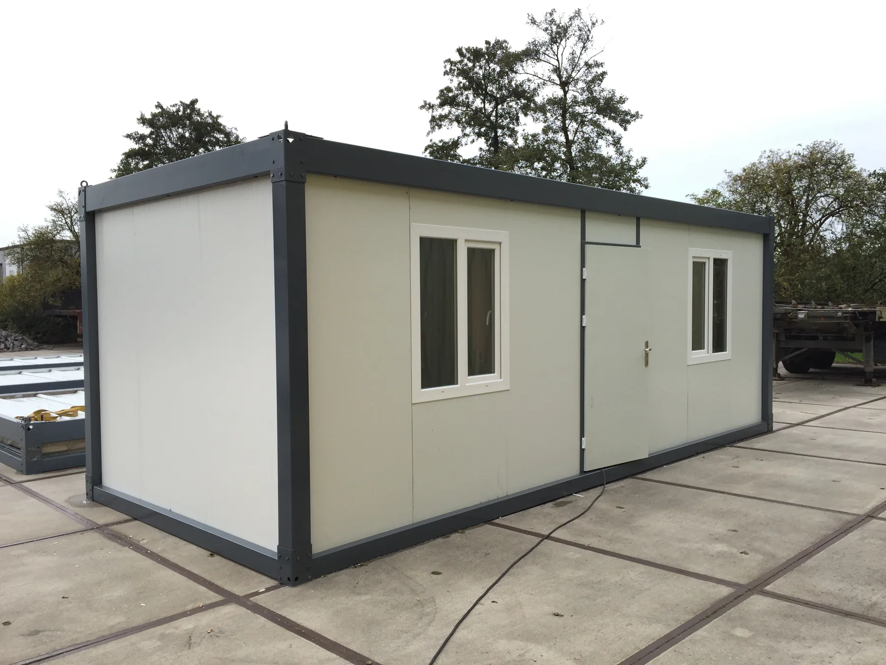 Completed white and charcoal flat-pack modular unit at Assen