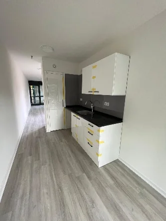 Fitted kitchen and corridor inside a Groningen accommodation unit